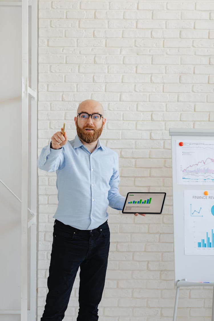 Businessman In Glasses Making Presentation In Office