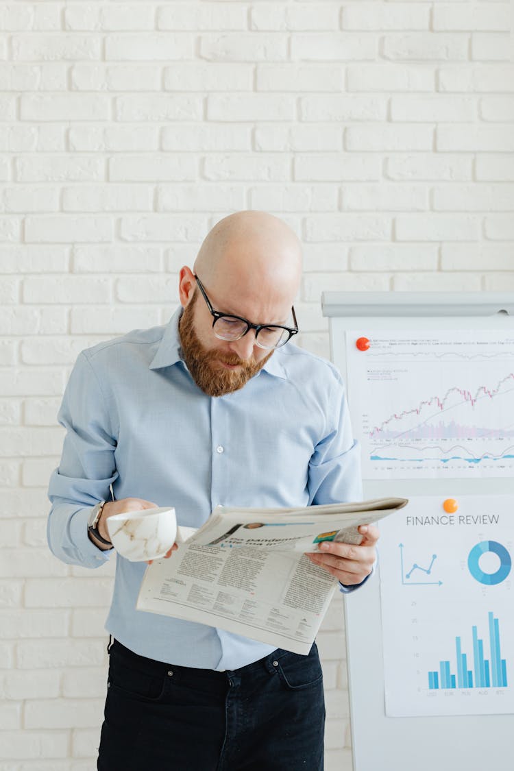 Man In Glasses Reading Newspaper