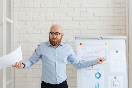 Confident businessman presents financial data on charts in a modern office setting.