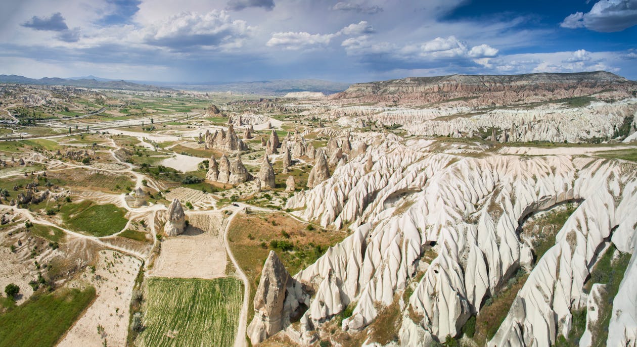 Rocky cliff with green terrain in sunny day