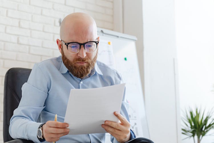 A Man Looking At Documents