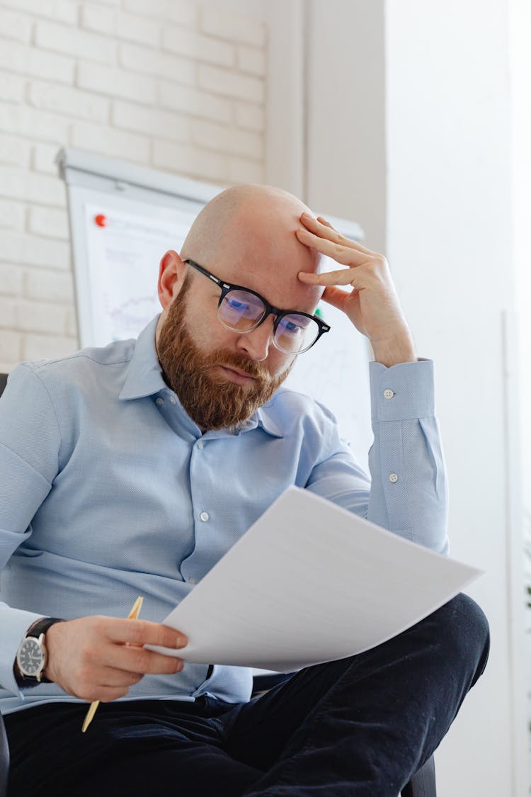 A Man Looking At Documents