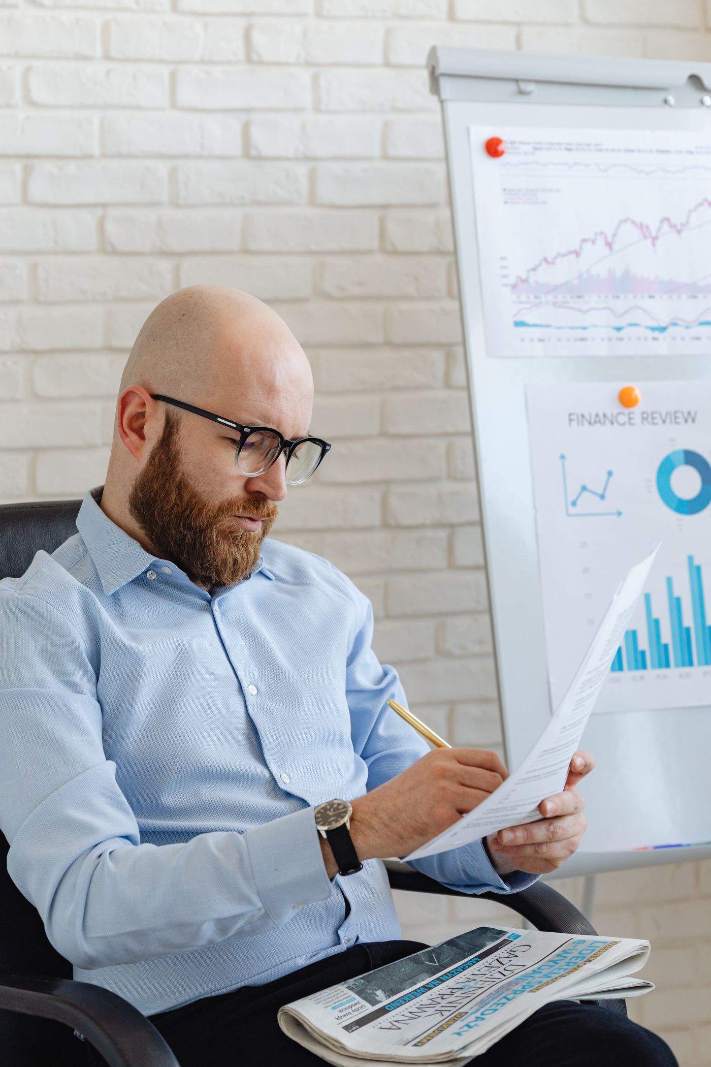 Business owner reviewing financial reports before making a major decision