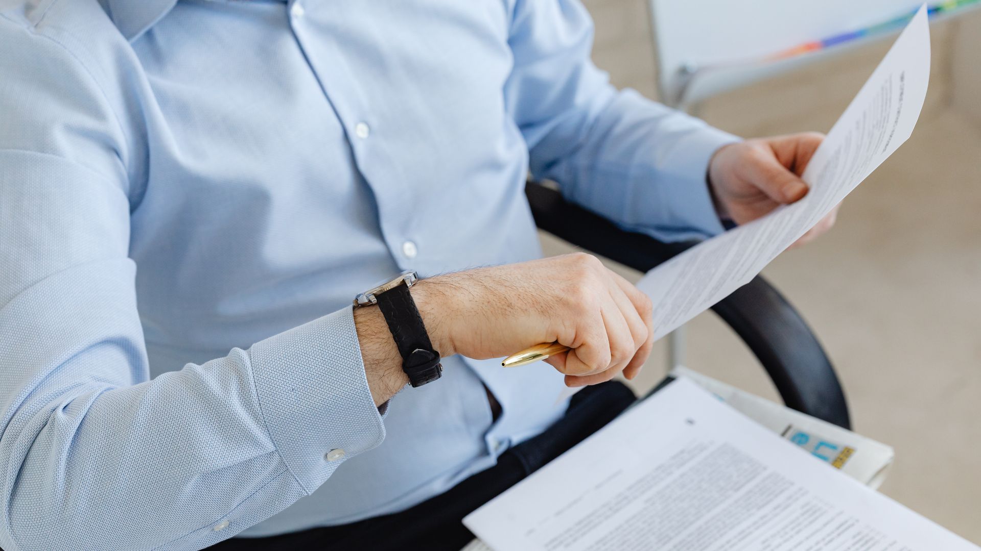 Businessman reviewing papers in office setting, highlighting analysis and attention to detail — artivigil review