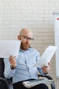 Man with Serious Face Looking at the Papers