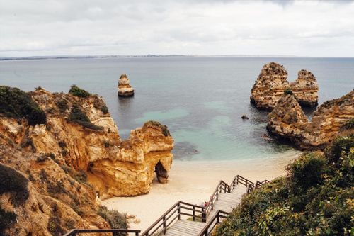 Free Stunning coastal landscape in Algarve with natural rock formations and clear ocean waters. Stock Photo