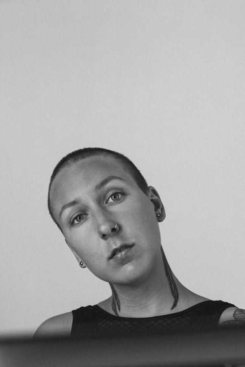 Free Black and white portrait of a woman with a shaved head and nose piercing. Stock Photo