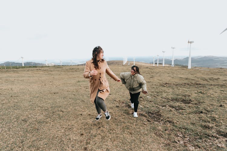 Two Women Running On The Ground