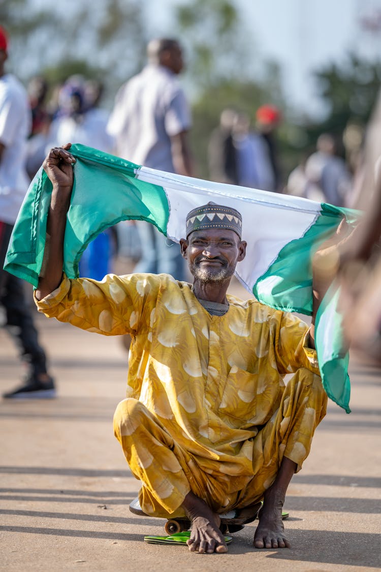 Old Man In Traditional Clothes With Flag