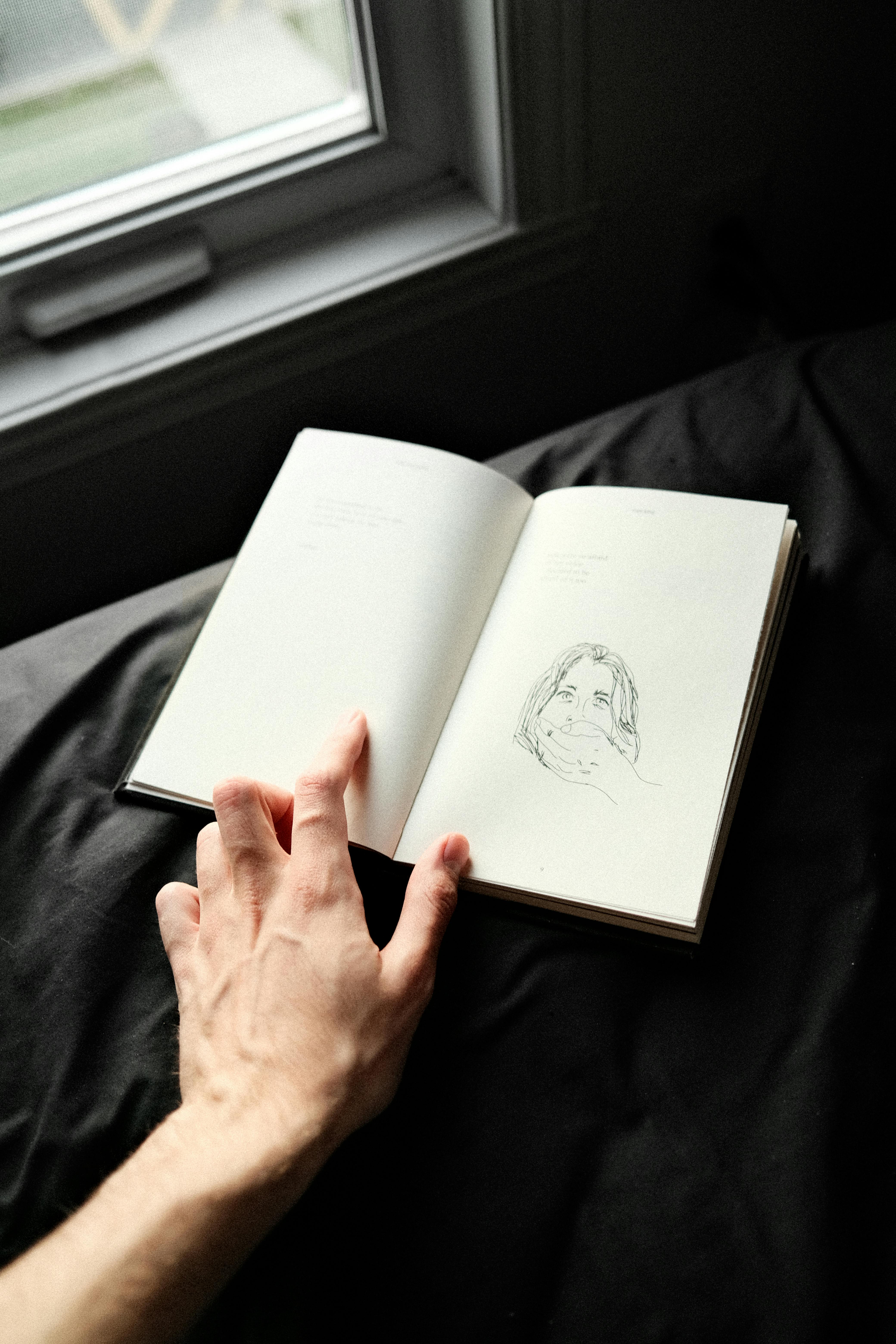 a person drawing on a sketch pad