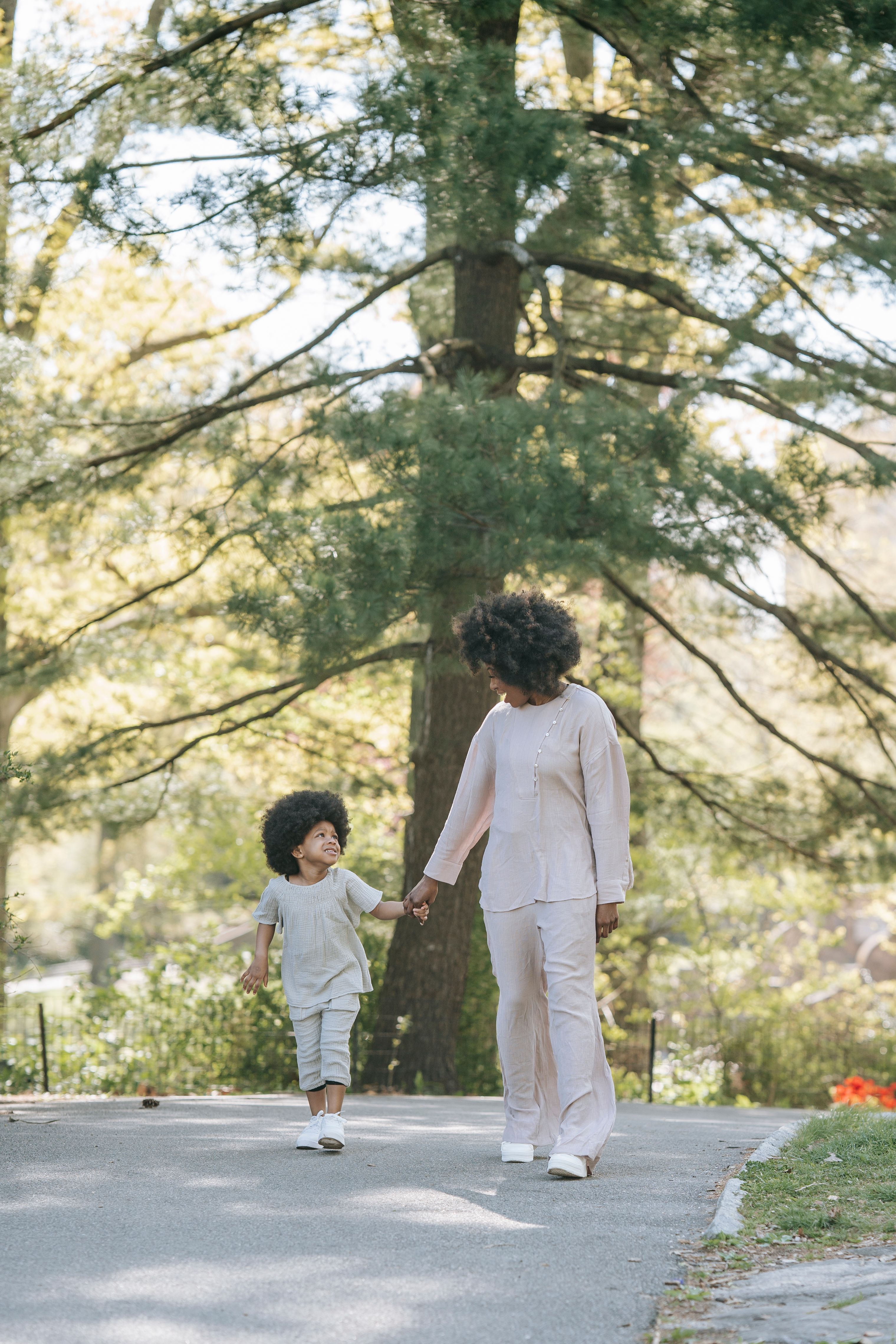 Woman and a Kid Walking Holding Hands · Free Stock Photo