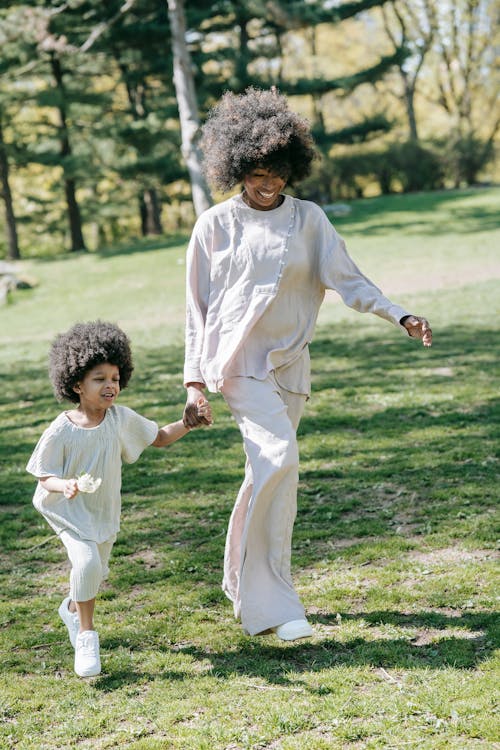 Shallow Focus of a Mother and Child  Walking on the Ground