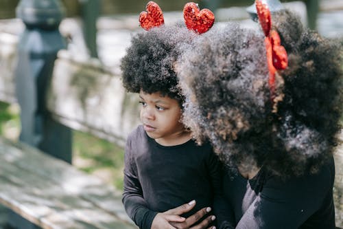 Free A Girl Being Held by her Mom at a Park Stock Photo