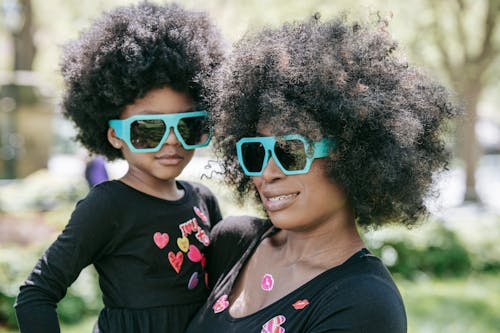 Free A Woman and her Daughter Wearing Matching Sunglasses Stock Photo