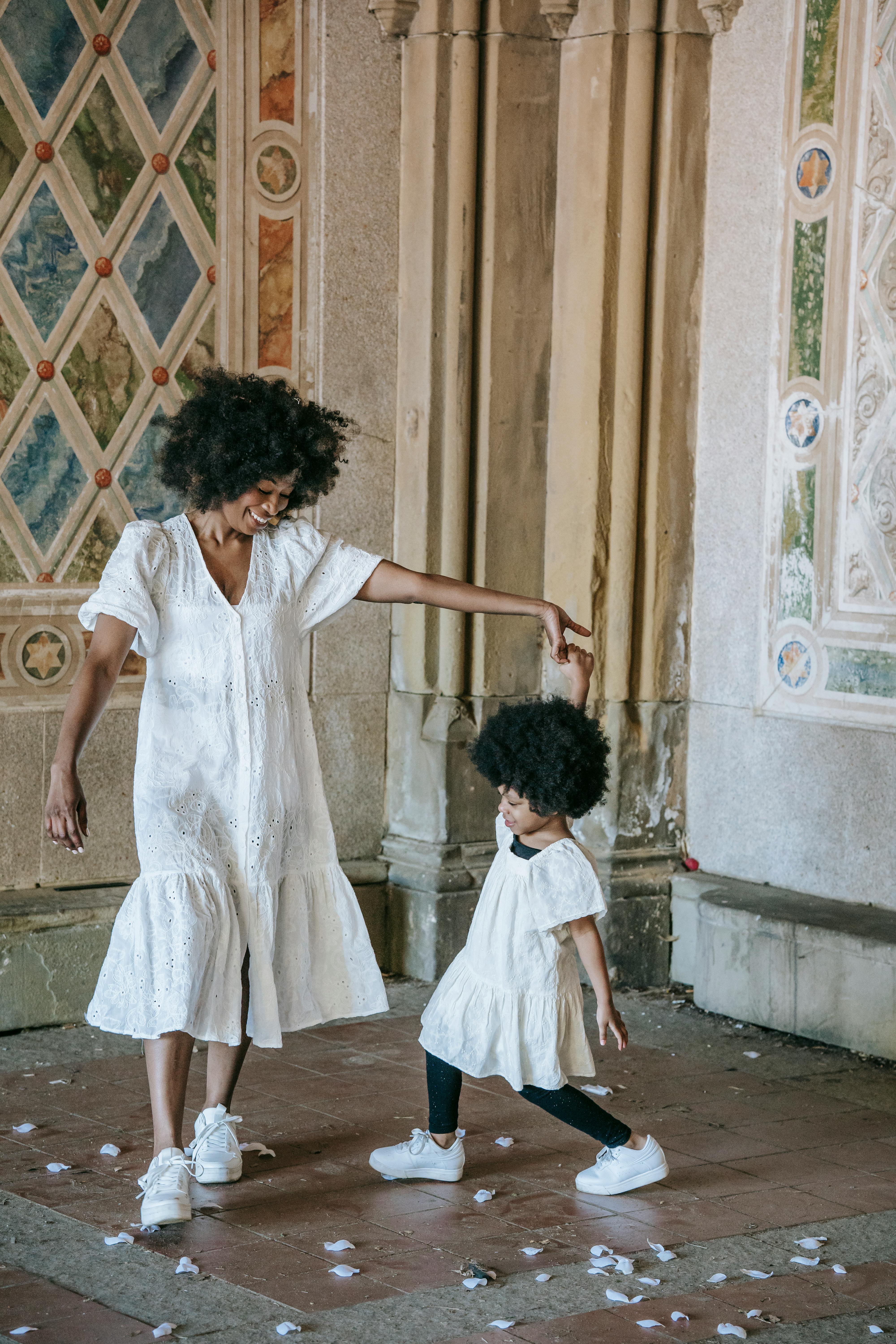 a happy woman dancing with her child