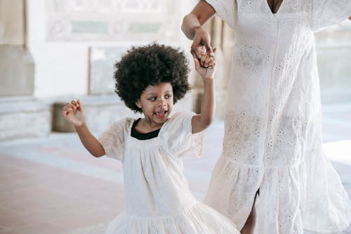 A Girl in White Dress Dancing with a Person in White Dress