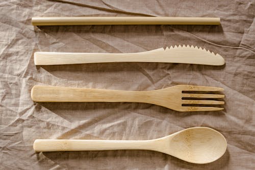 Free Brown Wooden Fork Lot on White Surface Stock Photo