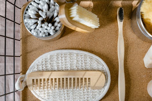 Eco-friendly wooden bathroom essentials including comb, toothbrush, and brush in a flat lay.
