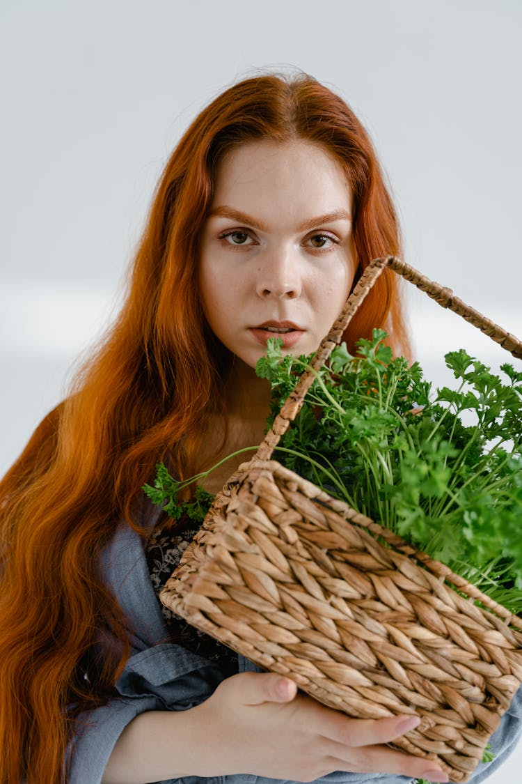 Woman Holding A Basket Of Herbs