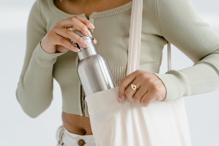 A Person In Gray Crop Top Holding Stainless Tumbler