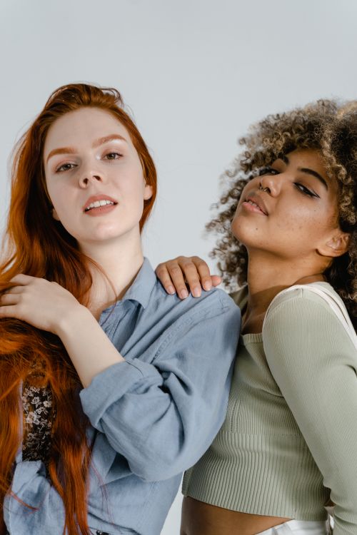 Free Close-up of two diverse women posing confidently, showcasing friendship and style. Stock Photo