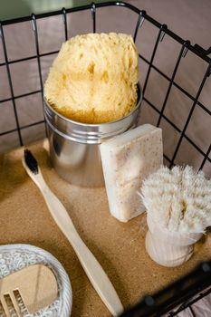 A collection of eco-friendly hygiene items in a rustic metal basket.