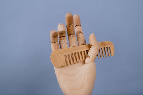 Brown Wooden Hand with Brown Wooden Comb