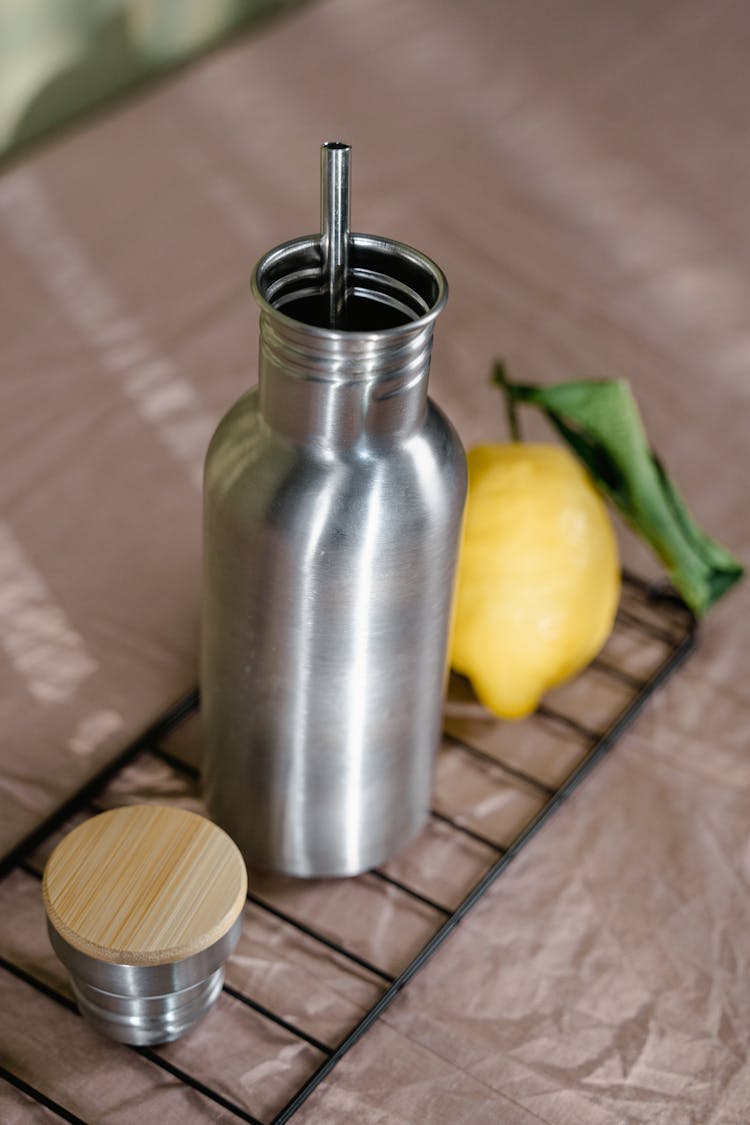 Insulated Stainless Steel Water Bottle Beside A Lemon Fruit