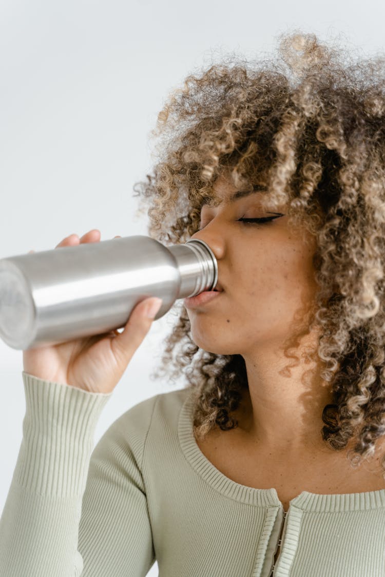 Close Up Photo Of Woman Drinking From A Tumbler