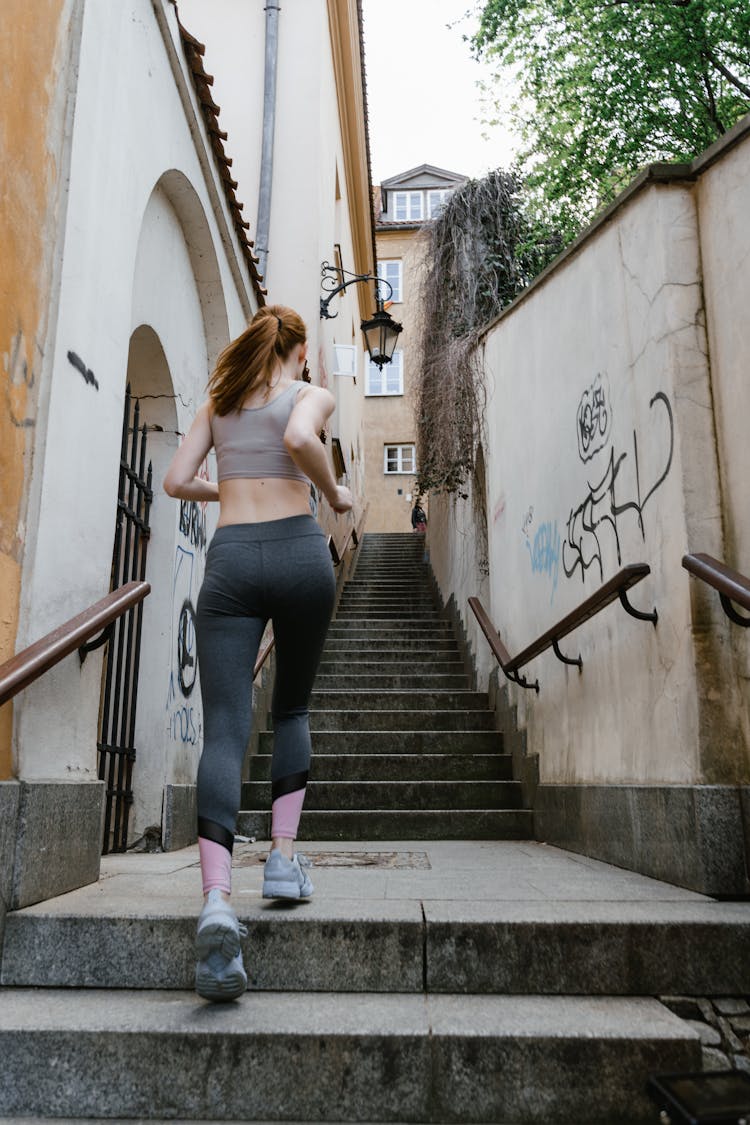 A Person In Active Wear Running Up The Steps