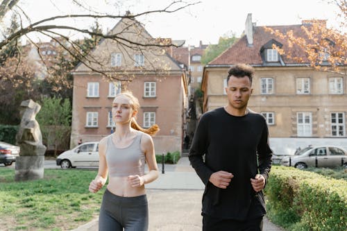 Free Man and Woman Running Outdoors Stock Photo