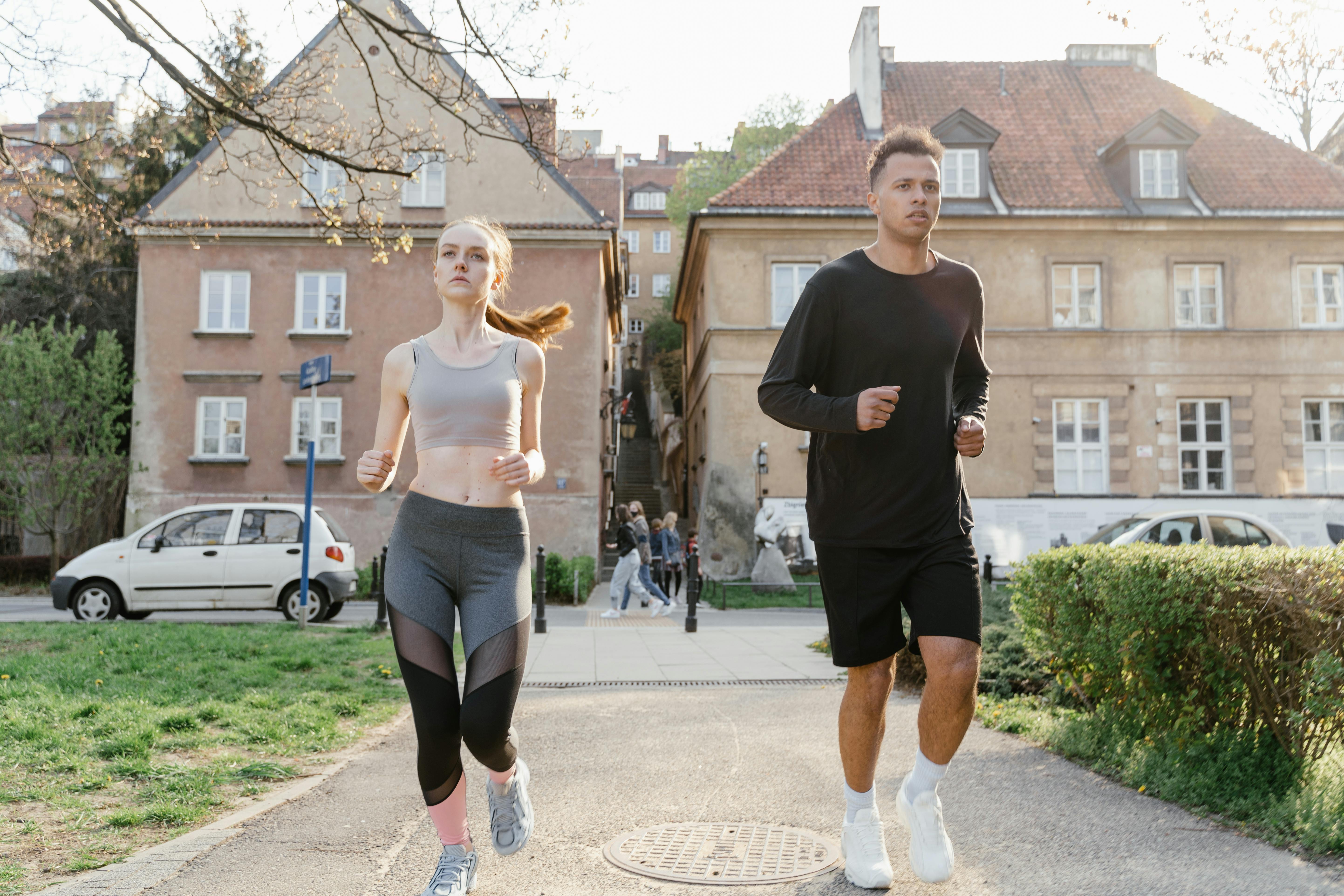 man and woman jogging on the street