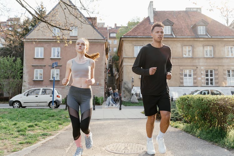 Man And Woman Jogging On The Street