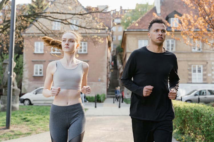 Man And Woman Jogging On The Street