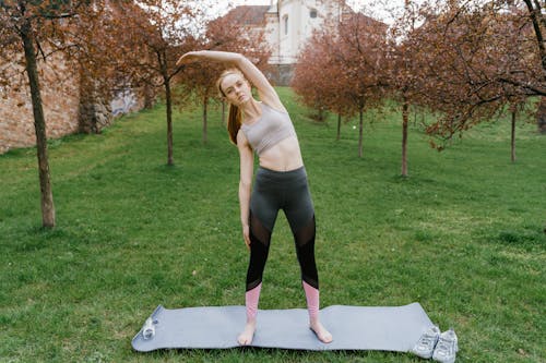 Free A Woman Stretching on a Yoga Mat Stock Photo