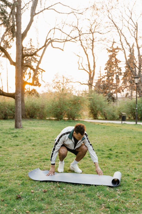 A Man Setting Up His Yoga Mat