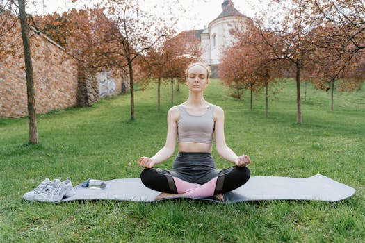 Woman meditating on yoga mat in park. Embracing wellness and tranquility surrounded by nature.
