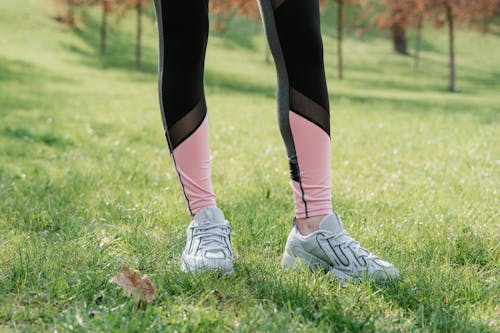 A Person in Black and Pink Leggings Wearing Rubber Shoes