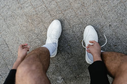 A Person Wearing White Sneakers