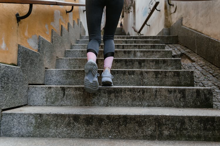 A Person Walking Up A Stairway