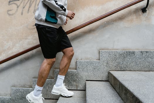 Close-up of a man running upstairs for fitness exercise outdoors.