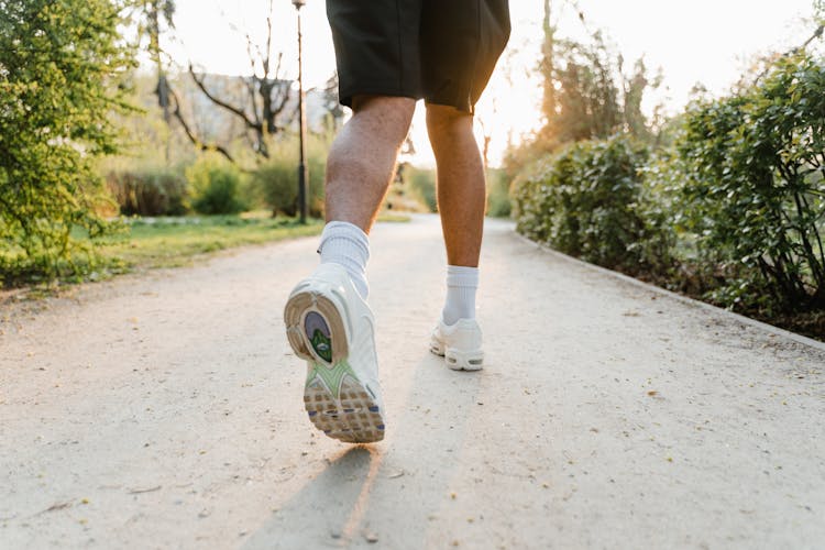 A Person In White Rubber Shoes Running