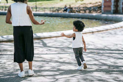 A Child Playing with her Mom at a Park