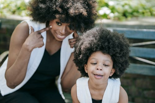 Free A Woman and a Young Girl Smiling at the Camera Stock Photo