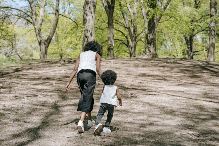 Mother And Child Walking In Park