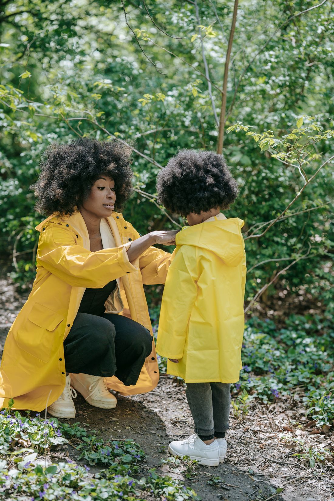 A mother zipping up her son's coat