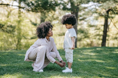 A Woman Tying her Child's Shoelaces