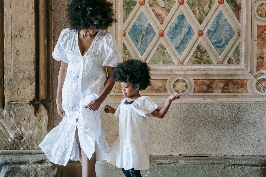 Mother and Her Daughter Wearing White Dresses