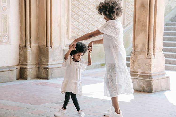 Happy Mother And Child Dancing Outdoors