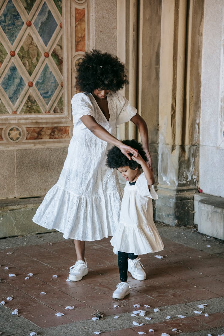 A Woman Dancing With Her Daughter